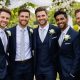 Groomsmen Posing Under Floral Wedding Arch