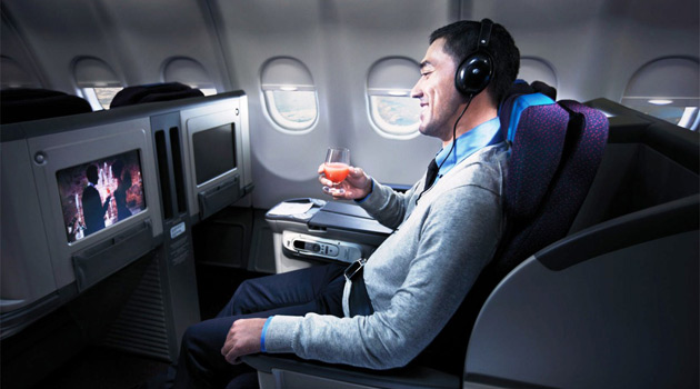 Man Watching A Movie On An Airplane