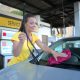 Woman in yellow t-shirt cleaning car