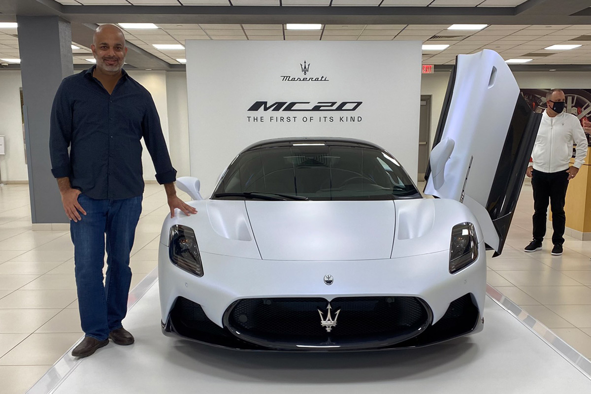 Sujeet Patel standing with the Maserati MC20