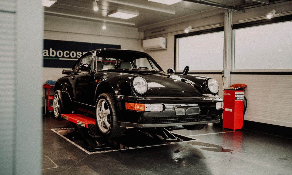 Porsche on a lift in the garage