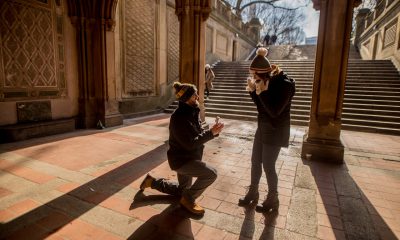 Man on one knee proposing to a woman