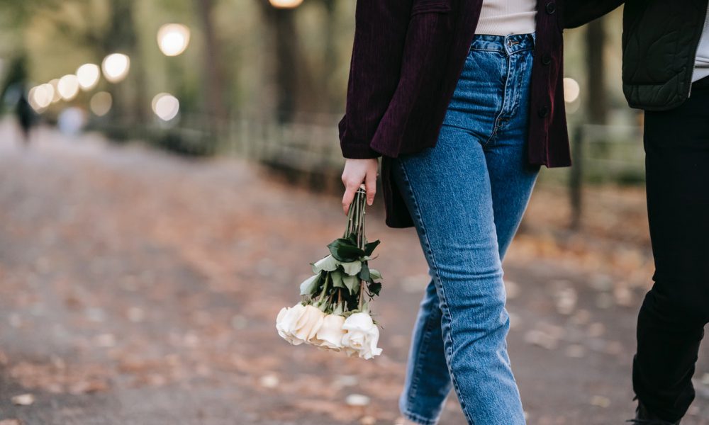 Woman with bouquet of fresh white roses