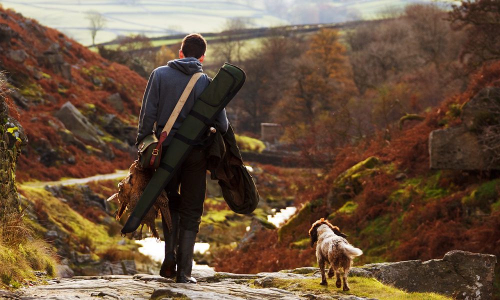 man hunting with dog