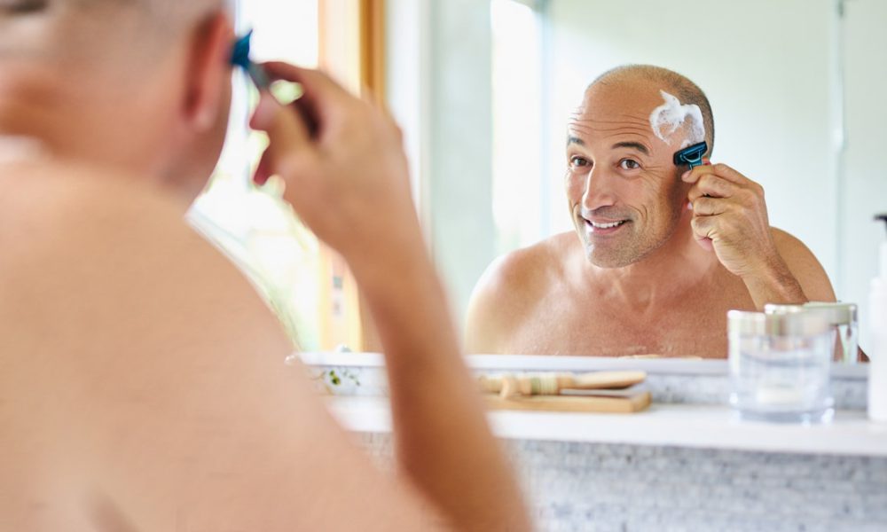 Man shaving his head