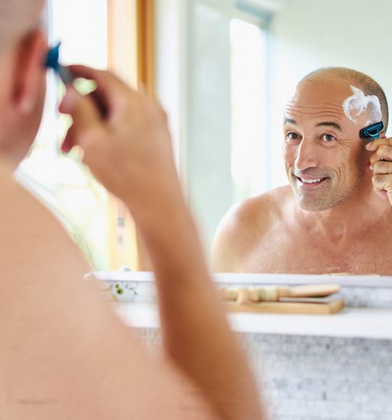 Man shaving his head