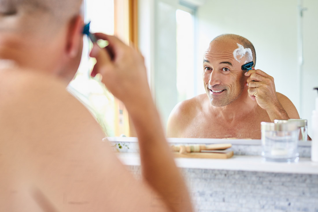 Man shaving his head