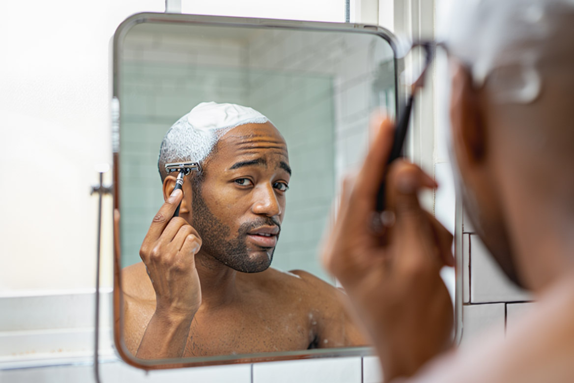 Man shaving his head